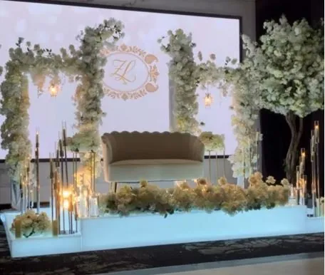 Backdrop lumineux avec monogramme, arches florales et sofa